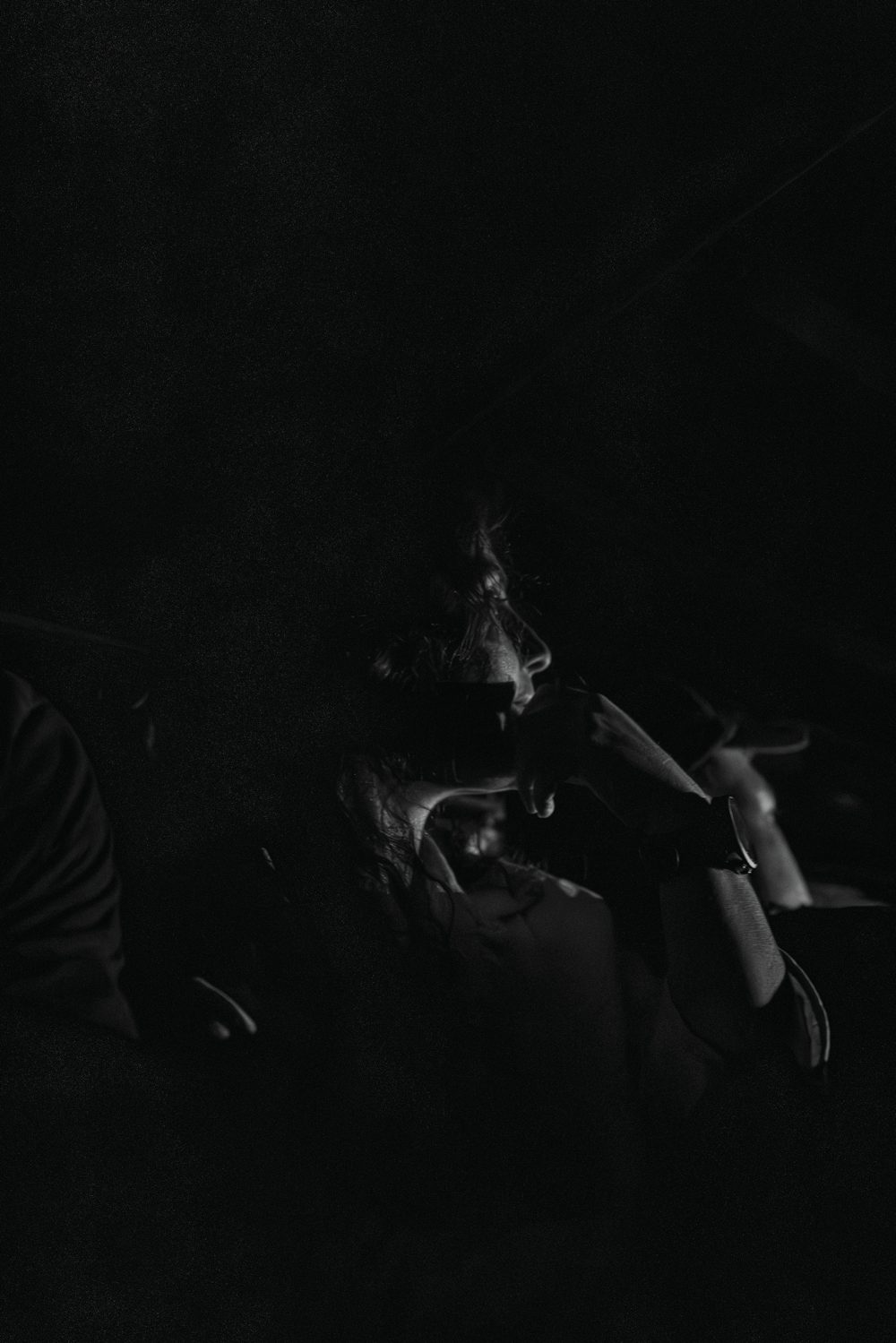 A passenger barely visible in the dark interior of a Jeep Willys in Filandia, Colombia.