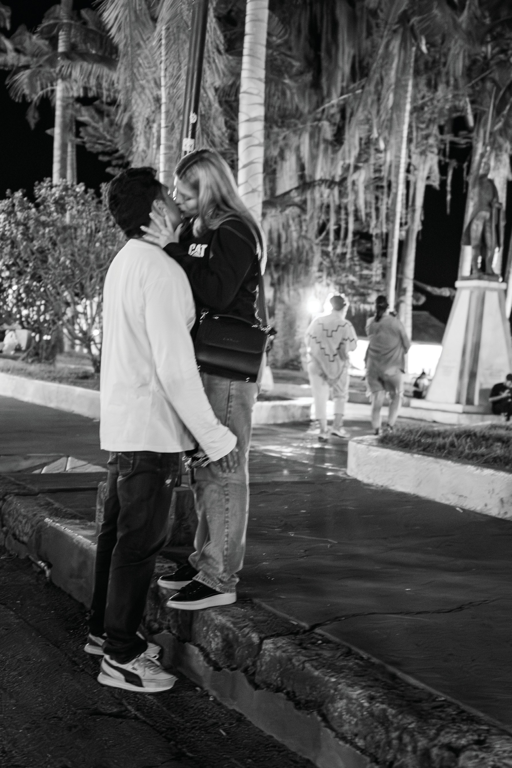 A young couple standing close together on a nighttime street in Salento, Colombia.